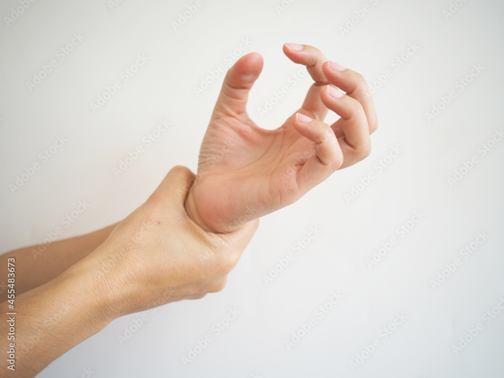 Acute pain in a woman wrist. woman holding hand spot of wrist pain on white background. Acute pain in a woman wrist. woman holding hand spot of wrist pain on white background.