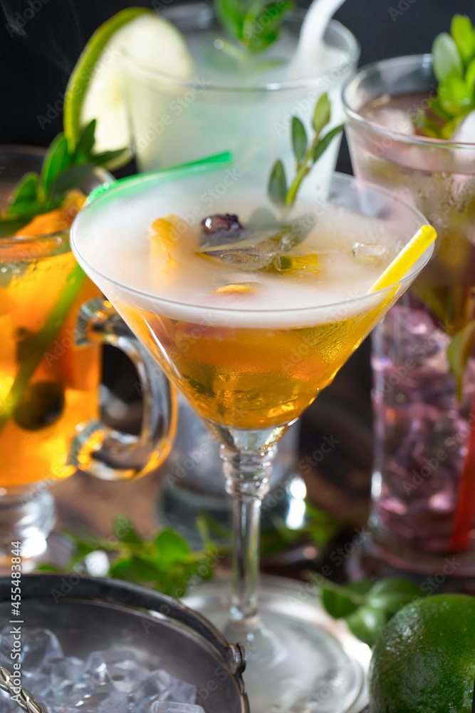 Cocktail in a glass with fruit on an old background.