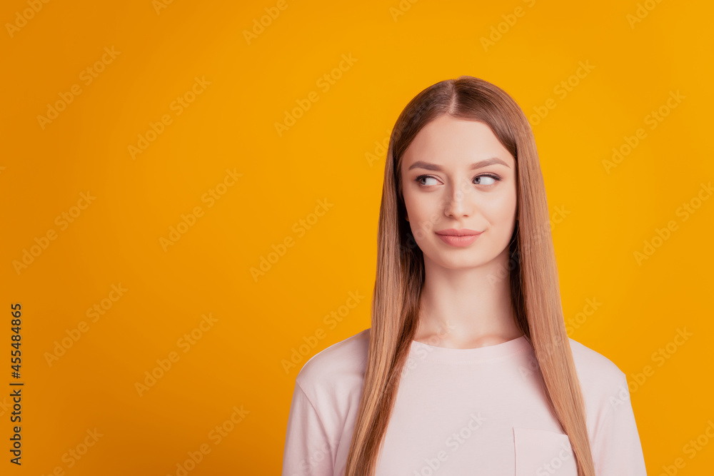 Portrait of positive curious lady look side empty space on yellow background Portrait of positive curious lady look side empty space on yellow background