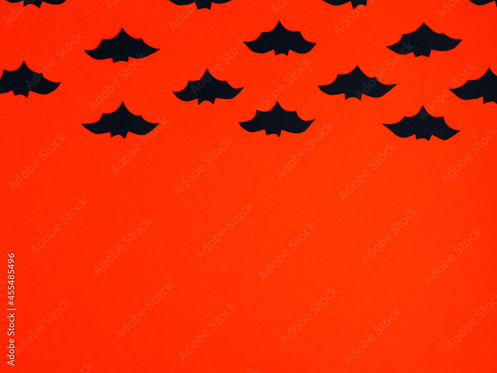 Dark blue silhouette of bats on orange. Background for Halloween party flyers. Place for your text. Dark blue silhouette of bats on orange. Background for Halloween party flyers. Place for your text.