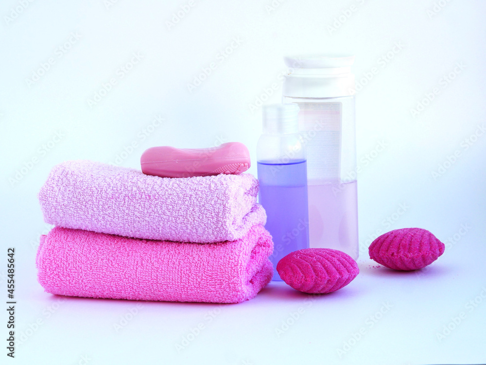 Spa set pink color. Towel, body oil, soap, bath bomb. Place for your text. Flat layout. Spa set pink color. Towel, body oil, soap, bath bomb. Place for your text. Flat layout.
