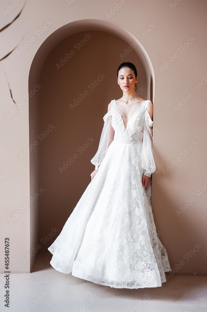 Smiling young woman posing in a wedding dress