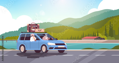old family driving in car on weekly holiday senior african american travelers couple traveling by car active old age