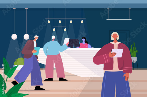 senior businesspeople using digital gadgets aged business people working in modern dark night office