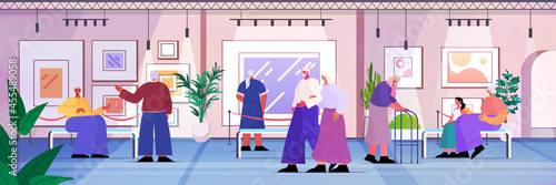 senior people visiting art gallery aged men women visitors viewing exhibits in museum old age concept