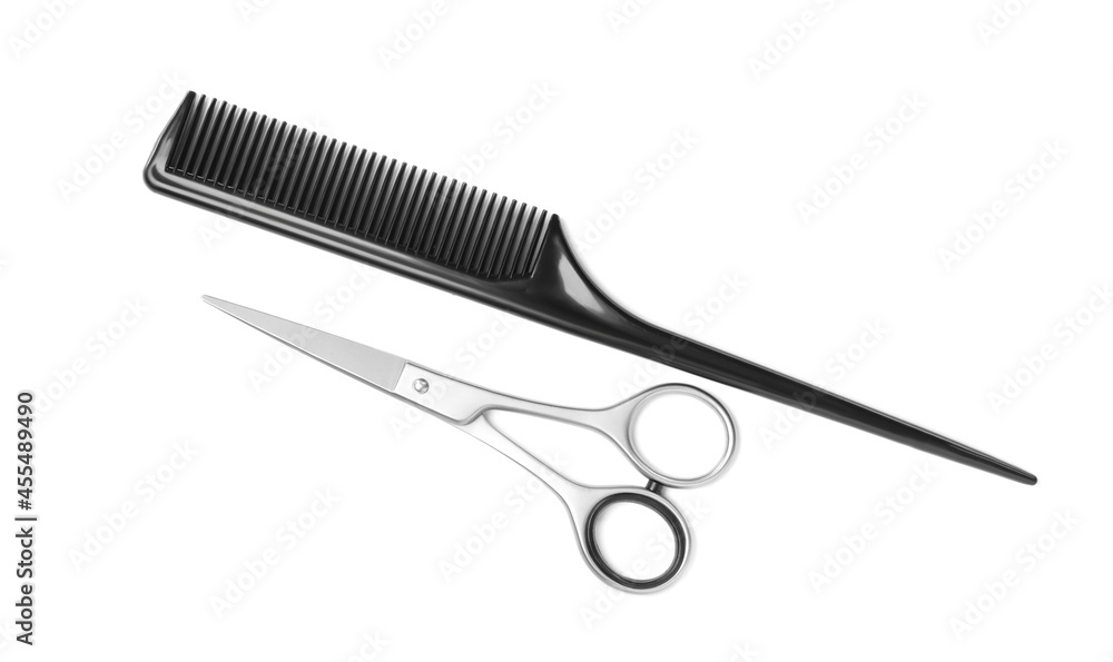New scissors and comb on white background, top view. Professional tool for haircut New scissors and comb on white background, top view. Professional tool for haircut