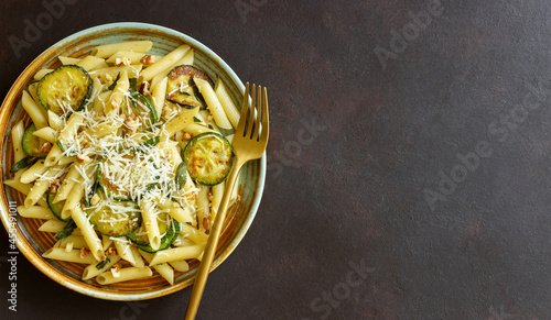 Penne pasta with zucchini, sage, nuts and parmesan cheese. Healthy eating. Vegetarian food. Italian food.