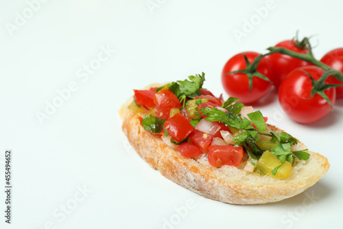 Delicious italian snack bruschetta and tomatoes on white background