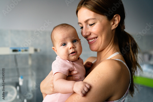 Portrait of beautiful mother with her baby in the hospital background