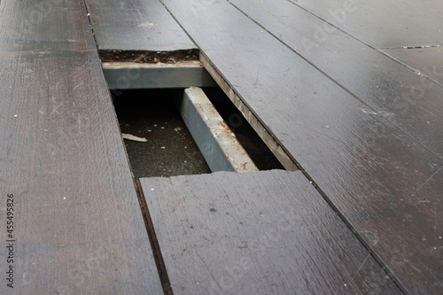The cement board floor is broken into holes, which can be dangerous if you are not careful.