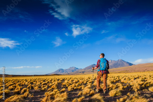 Man solo traveling backpacker hiking in the mountains active healthy lifestyle adventure journey vacations