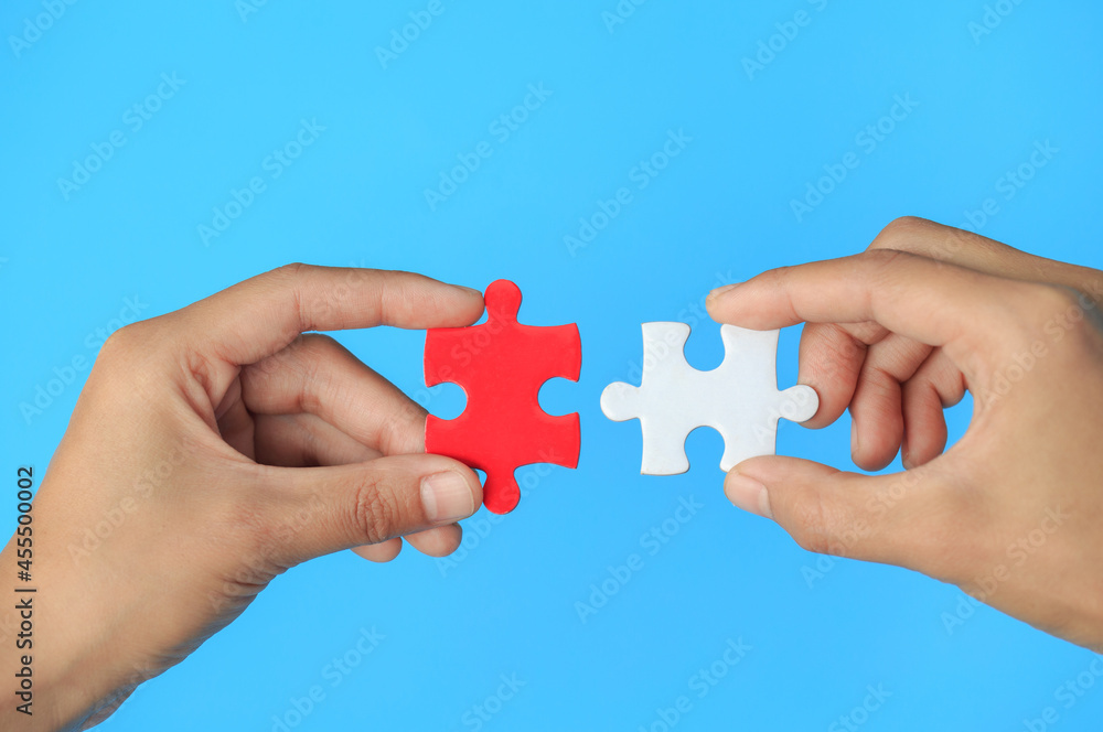 Closeup hand of man connecting jigsaw puzzle with sunlight effect, Business solutions, success and strategy concept Closeup hand of man connecting jigsaw puzzle with sunlight effect, Business solutions, success and strategy concept