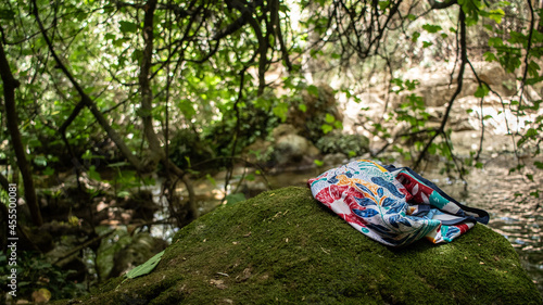 Paisaje tranquilo en la sierra de Sevilla, roca con pañuelo de colores en la orilla del rio photo