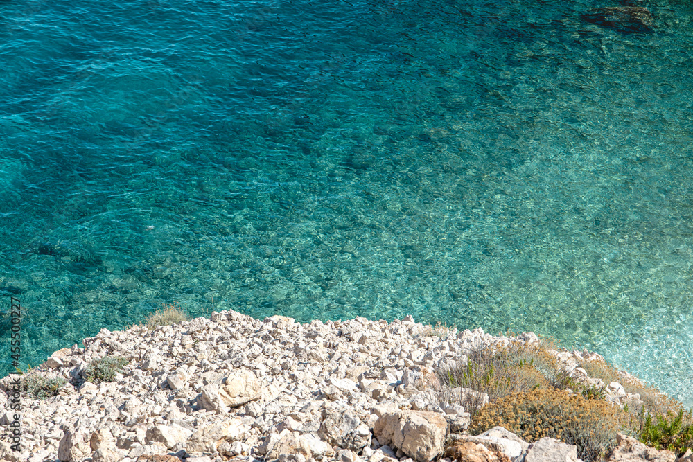 Mediterranean white stone beach over turquoise water. 