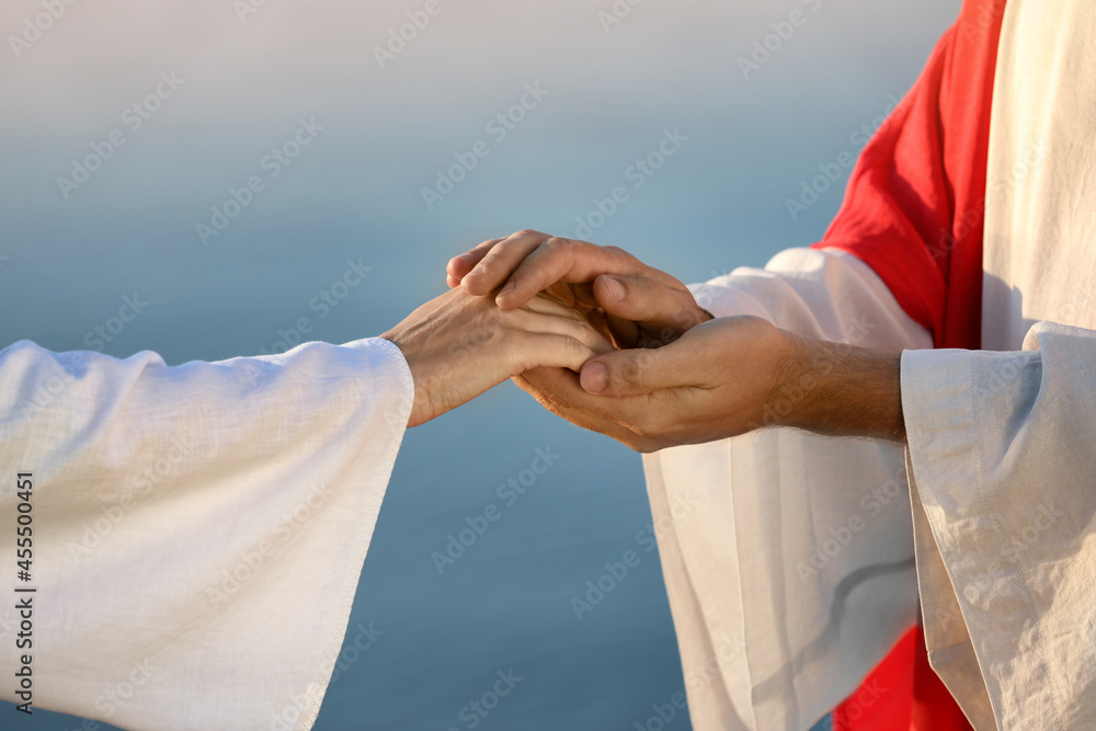 Jesus Christ holding woman's hand near water outdoors, closeup Stock ...