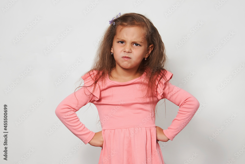 Cute girl posing with hands on hip against white background Cute girl posing with hands on hip against white background