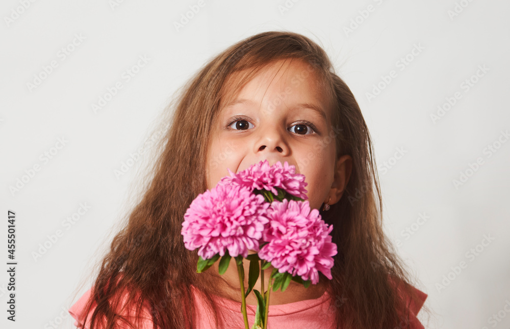 Portrait of a little girl with a flowers bouquet