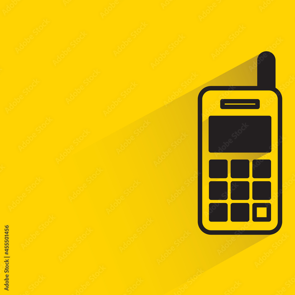 mobile phone with shadow on yellow background mobile phone with shadow on yellow background