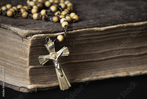 Old Catholic rosary and tattered Bible detail