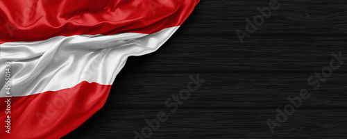 Close Up of Austria flag on the black wooden background 3D render