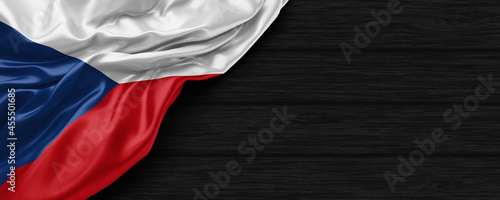 Close Up of Czech Republic flag on the black wooden background 3D render