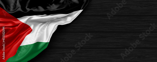 Close Up of Palestine flag on the black wooden background 3D render