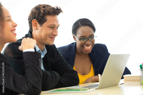 Business man manager leader in meeting with two woman analyzing ducuments on laptop computer in home office. photo