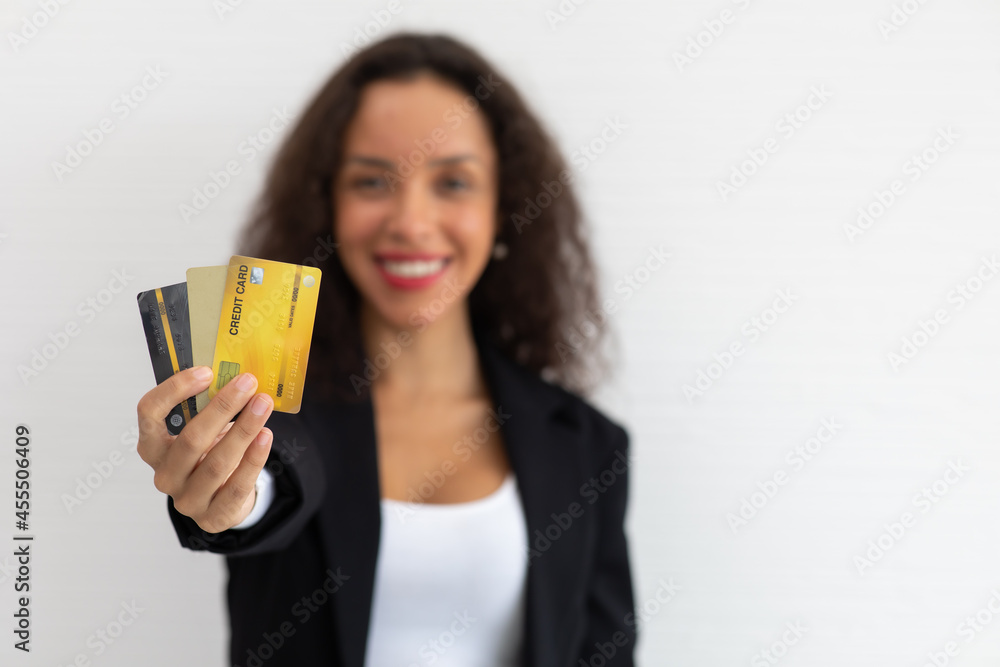 portrait cheerful excited latin business woman curly hair model holding credit card on hand. portrait cheerful excited latin business woman curly hair model holding credit card on hand.