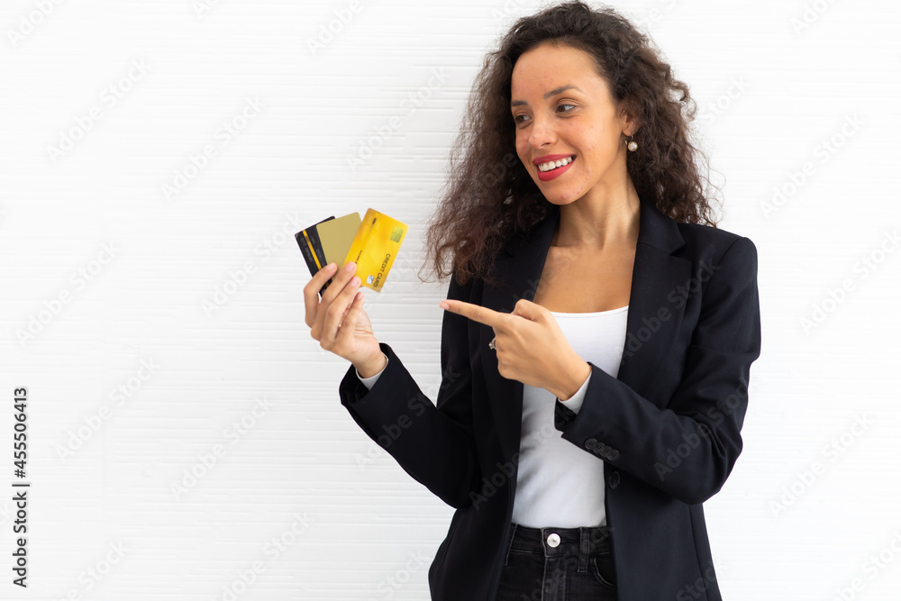 portrait cheerful excited latin business woman curly hair model holding credit card on hand. portrait cheerful excited latin business woman curly hair model holding credit card on hand.