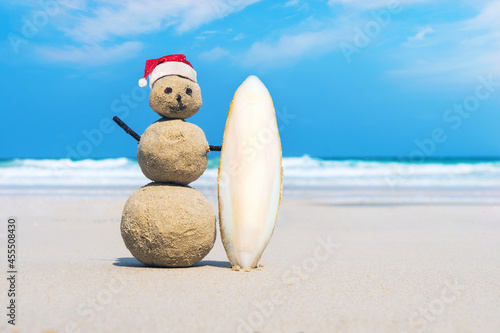 joyful Sandman of white sand on the clean beach of an exotic island on the background of blue sea and cloudy sky. photo