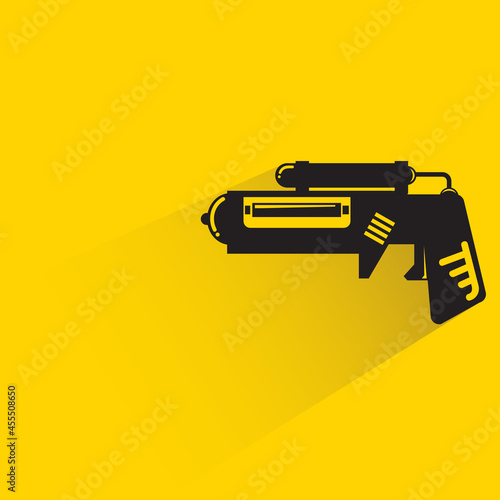 space gun with shadow on yellow background