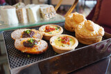 Savoury high tea dishes of meatball with chili, bacon egg tart and chicken pie.         
