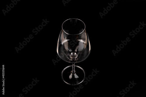 Empty transparent wine glass on the black background