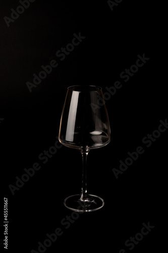 Empty transparent wine glass on the black background