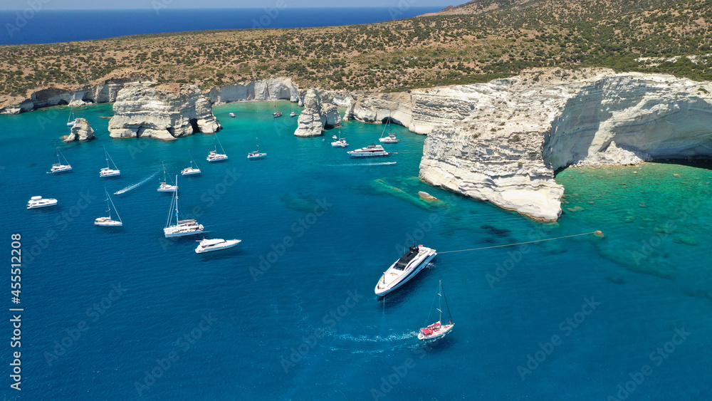 Obraz premium Aerial drone photo of Kleftiko a beautiful scenic white volcanic rock formation bay visited by sail boats and yachts with turquoise crystal clear sea and caves, Sea Meteora of Greece, Milos island