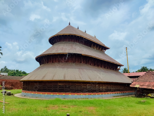 Adoor Temple ancient Kerala architecture view under the sky. Beautiful design temple carvings surrounded by green grasses