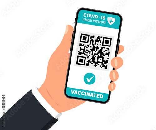 Health passport with qr code on smartphone screen. Hand holding smartphone with vaccination certificate. Concept of travel during the COVID-19 outbreak. The vaccinated person using Apps with QR code