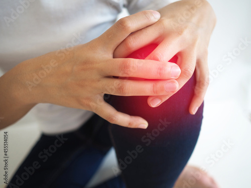 woman with arthritis in her knee and touches the pain. health concept.