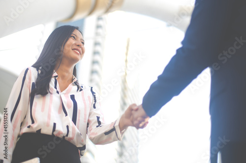 businessman shaking hands on a business cooperation agreement. Successful business woman handshaking after good deal