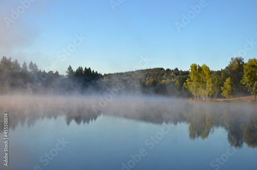 Rising fog at the Lake. Lac de Ponty, Ussel, France. photo