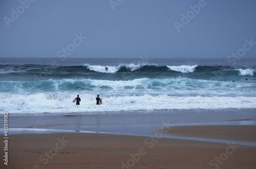 Surfers on the Algarve coast. Praia do Beliche. Sagres, Portugal. photo