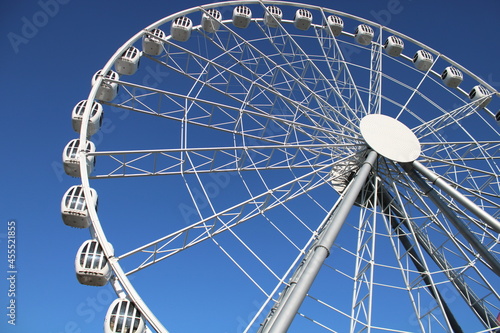 Ferris wheel in amusement park. The atmosphere of fun and romance.
