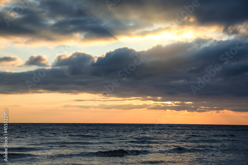 Picturesque view of beautiful sky with clouds over sea at sunset