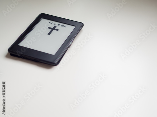 Electronic book with holy bible. Religion and tech concept