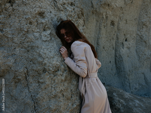 pretty woman posing near rocks in the sand model Travel