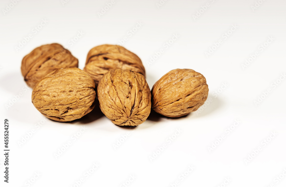 A group of five walnuts isolated on a white background. Healthy lifestyle and food A group of five walnuts isolated on a white background. Healthy lifestyle and food