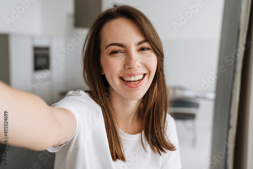 Smiling young woman in lounge wear standing