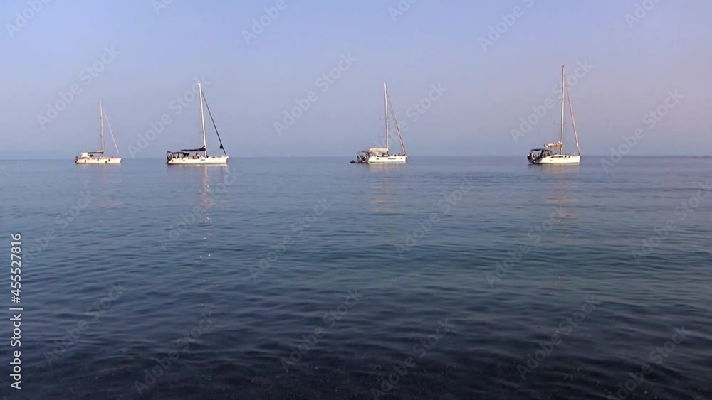 Sailing ships against the horizon with the undertow of the sea on the foreshore. Sailing ships against the horizon with the undertow of the sea on the foreshore.