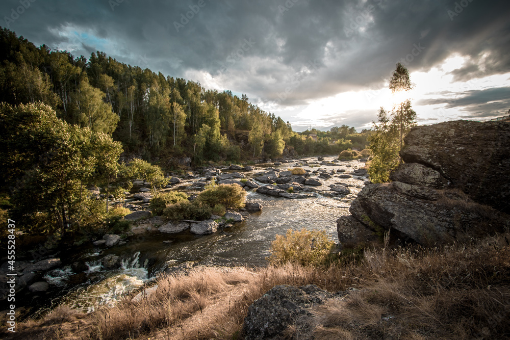 A stormy river with stones and a forest landscape in the Sverdlovsk region. Howler's threshold