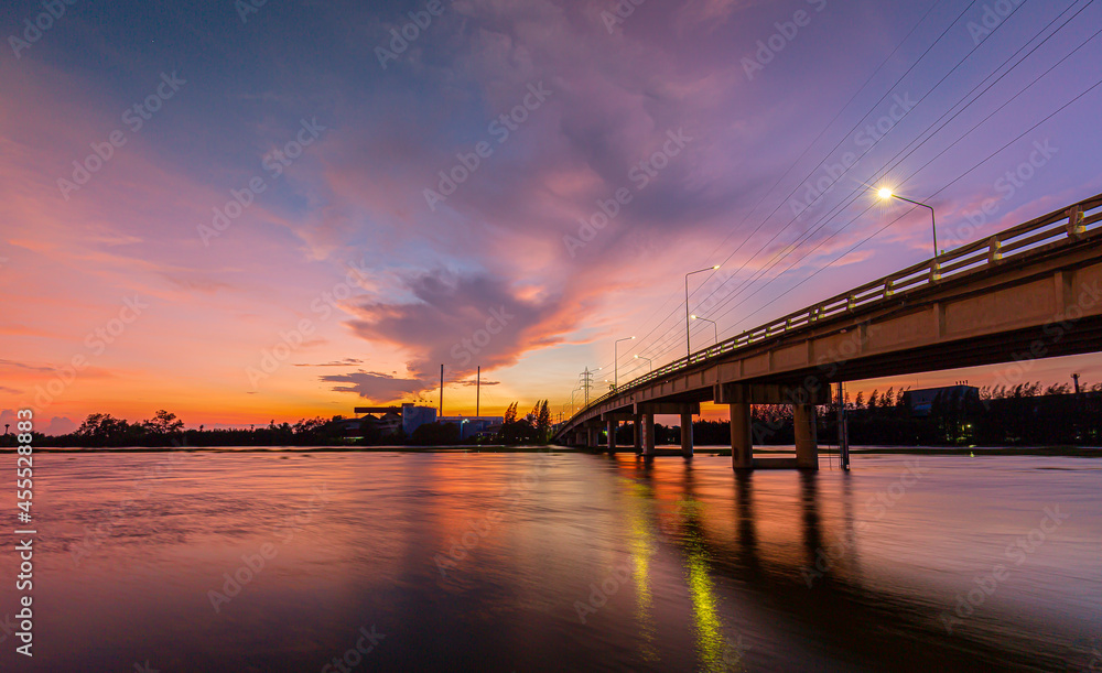 Bridge over river in the evening. The light from the lamp to the reflector surface,Container Terminal in Hamburg, Germany. Bridge is called Koehlbrandbruecke - a bridge about the harbor.